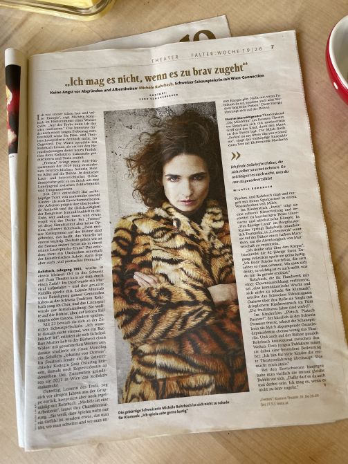 Ein Zeitungsbericht. Auf dem Foto eine Frau mit wilden Haaren in Leopardenmantel.